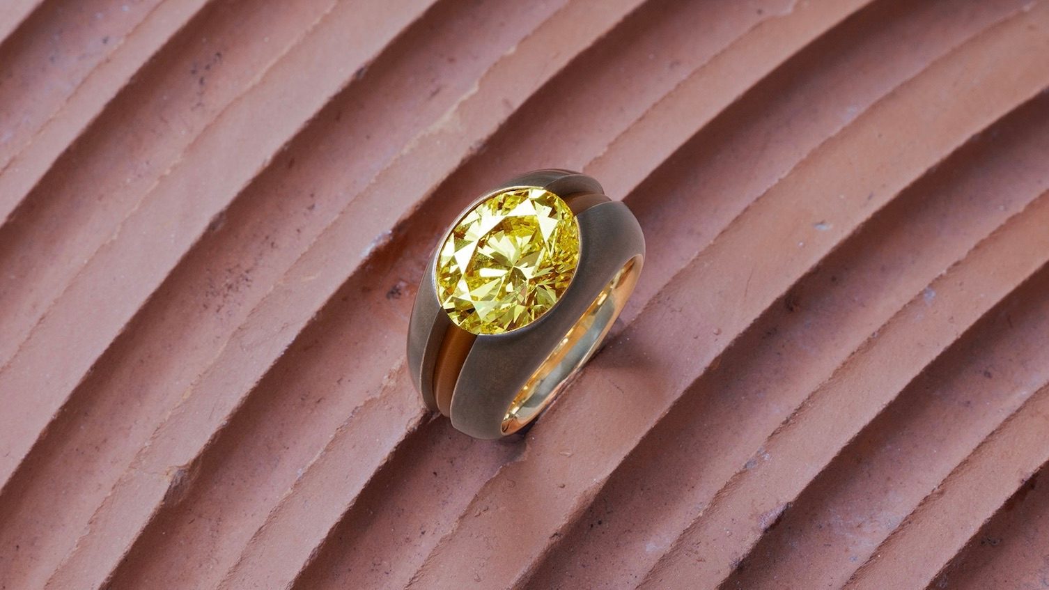 Hemmerle ring, Fancy Vivid Yellow diamond weighing over 6.2 ct., set in bronze, aluminum, and an inner band of yellow gold. (Courtesy of Hemmerle)
