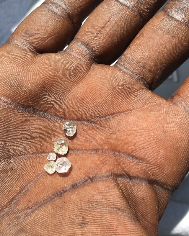 Diamond Traceability Artisanal Miner holding rough diamonds.