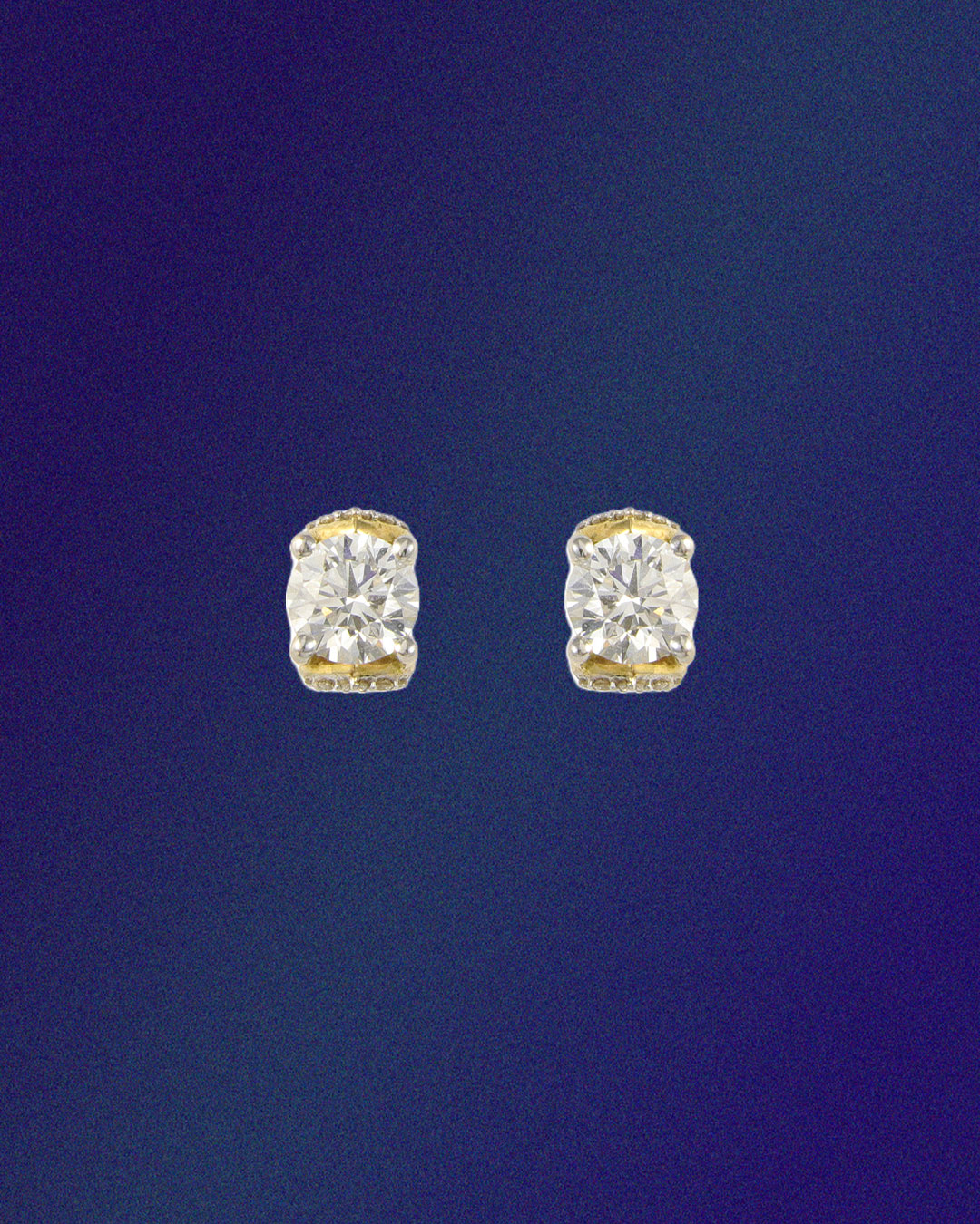 Om natural diamond earrings with yellow gold accents.