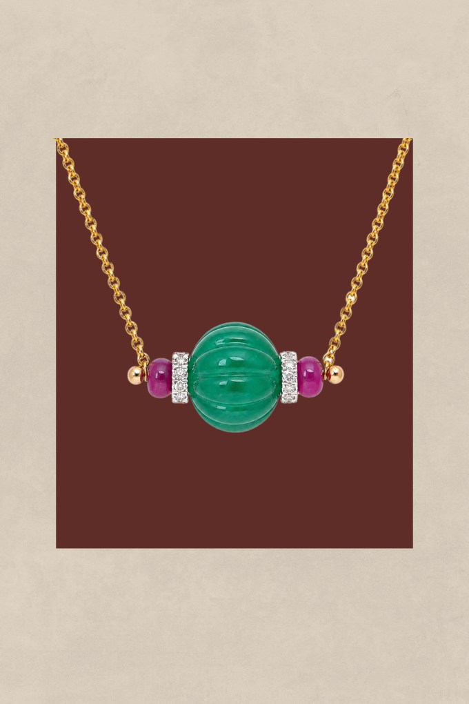 Akshat Ghiya wearing a carved emerald and natural diamond pendant.