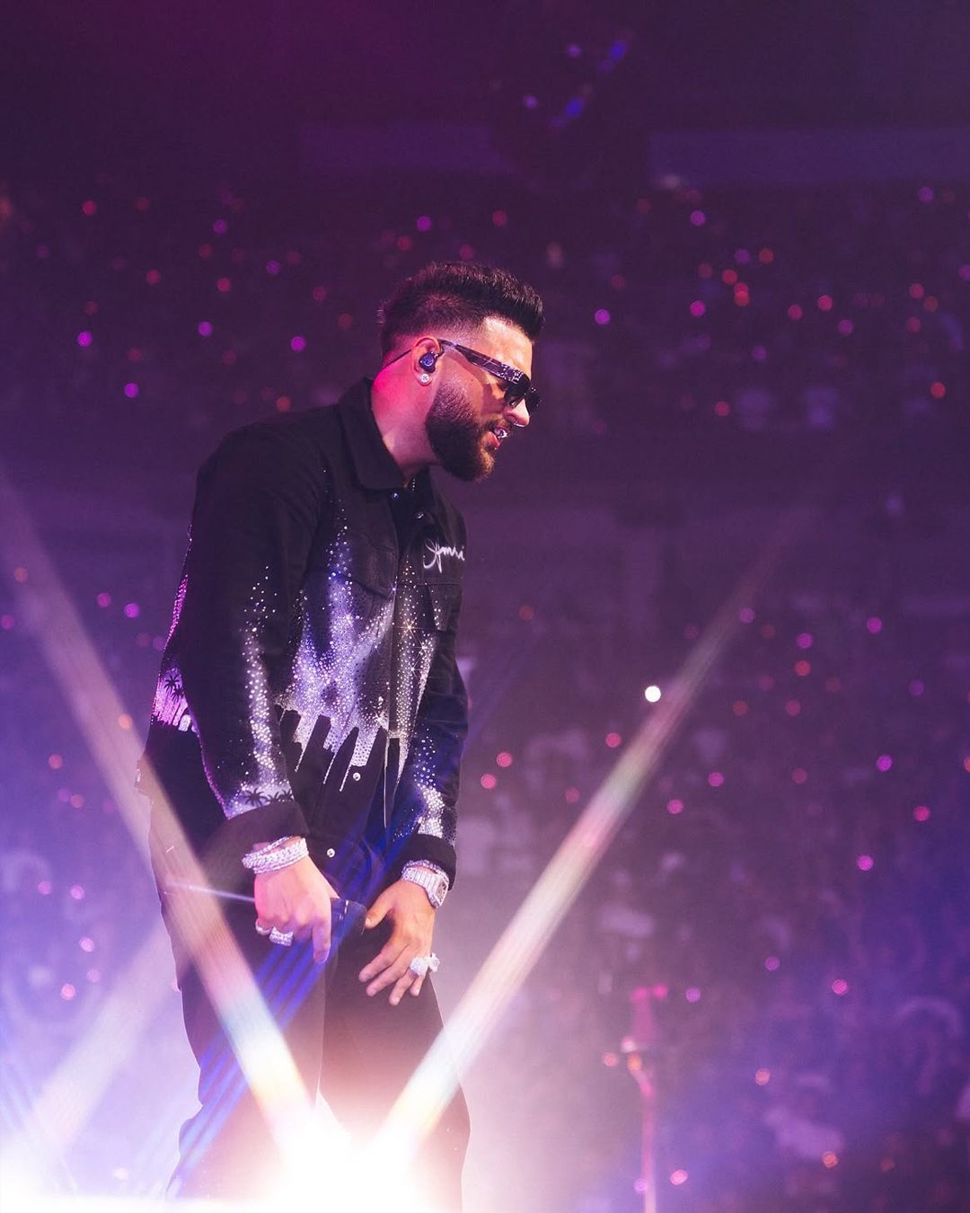 Karan Aujla wearing diamond jewellery during performances