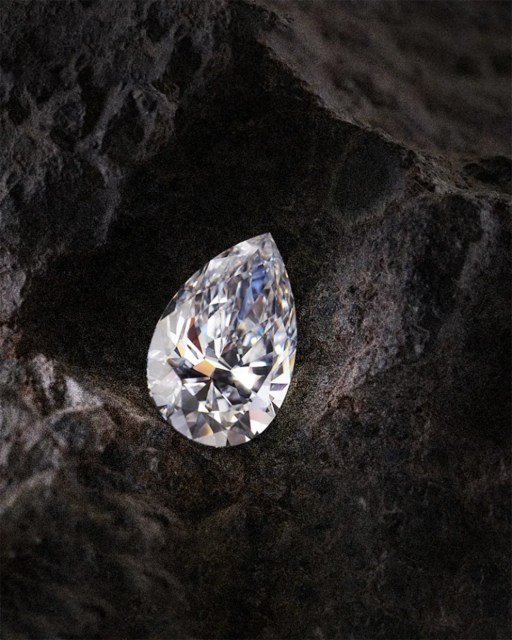 Pear-shaped diamond on dark stone